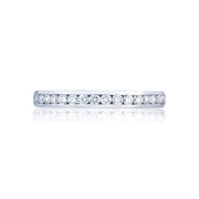 Sleek and smooth; this elegant diamond wedding band hugs channel set round brilliant diamonds halfway around the band. A perfect complement to your Tacori diamond engagement ring; but stunning all on its own.