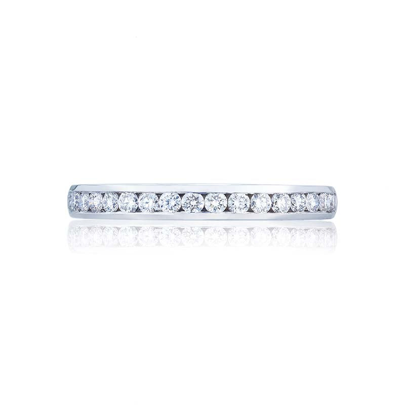Sleek and smooth; this elegant diamond wedding band hugs channel set round brilliant diamonds halfway around the band. A perfect complement to your Tacori diamond engagement ring; but stunning all on its own.