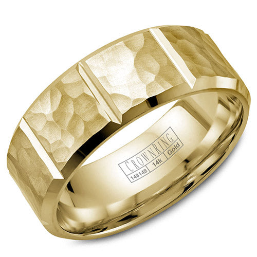 A yellow gold wedding band with a hammered finish and notch detailing.
