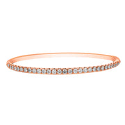 This diamond bracelet presents a neat row diamonds set on the top side of this rose gold bracelet. Simply sophisticated, this bangle bracelet shimmers with round-cut diamonds set in 18k gold.