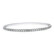 This diamond bracelet presents a neat row diamonds set on the top side of this white gold bracelet. Simply sophisticated, this bangle bracelet shimmers with round-cut diamonds set in 18k gold.