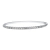 This diamond bracelet presents a neat row diamonds set on the top side of this white gold bracelet. Simply sophisticated, this bangle bracelet shimmers with round-cut diamonds set in 18k gold.