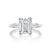Slim baguettes give a sophisticated twist to this emerald cut diamond engagement ring. With three times the charm and signature Tacori detailing decorating the mounting for sophisticated glitz from all angles; this ring is a keeper.