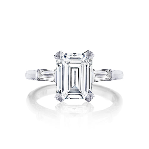 Slim baguettes give a sophisticated twist to this emerald cut diamond engagement ring. With three times the charm and signature Tacori detailing decorating the mounting for sophisticated glitz from all angles; this ring is a keeper.