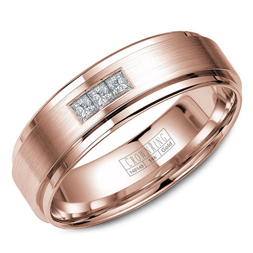 A wedding band in rose gold with brushed center and three diamonds in a prong setting.