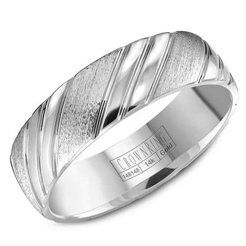 A wedding band in white gold with carved pattern detailing.