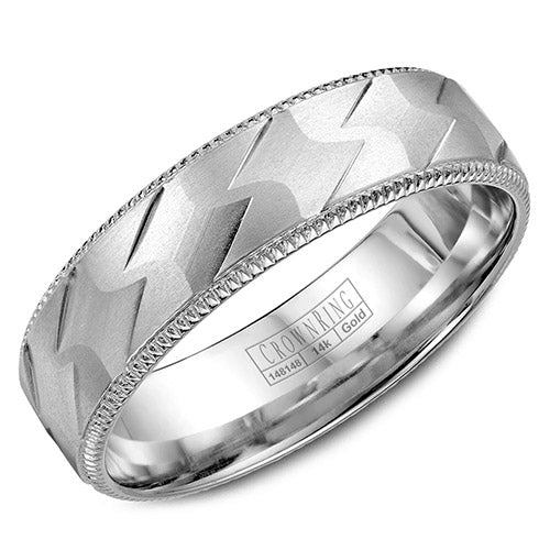 A white gold wedding band with a patterned center and milgrain detailing.