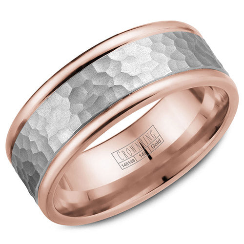 A rose gold wedding band with hammered white gold center.