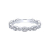 This Gabriel & Co. wedding band has an alternating east-west oval and round bezel design. Stack this wedding band next to other wedding bands for your own unique look! 