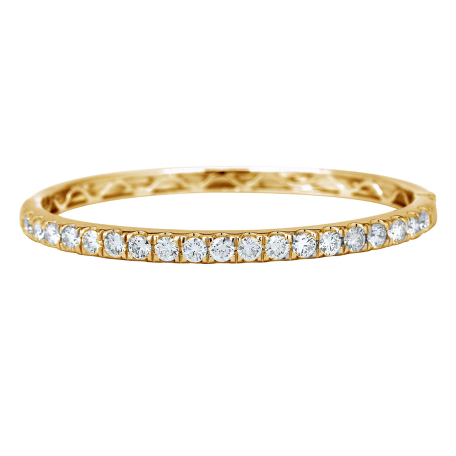 The majestic diamond bangle with superior craftsmanship is sure to be remembered for its striking beauty and design. Simply sophisticated, this bangle bracelet shimmers with round-cut diamonds set in18K Yellow Gold. The diamonds are G-H in color, SI in clarity. 