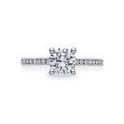 A single stream of round; channel set diamonds ignites a radiant center diamond for sophisticated simplicity.This engagement ring can accommodate a variety of center diamond sizes; starting at 0.5 carats; available by special order.