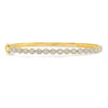 Diamonds glitter across the top of this 14K yellow gold diamond pave bangle bracelet! Each diamond is surrounded by a diamond halo giving the bracelet a bigger diamond presence. Since this is a hinged bangle, it will fit to the wearers wrist better than a round bangle! 