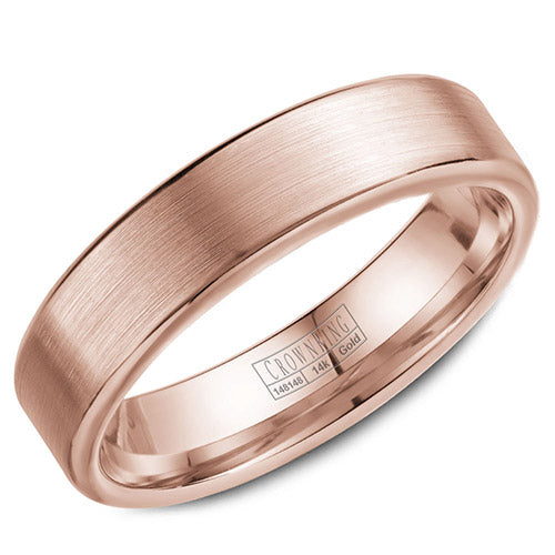 A wedding band in rose gold with a brushed center and polished edges .