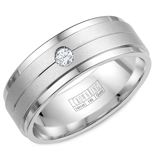 A white gold wedding band with a sandblast center and a round diamond.