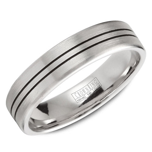 A wedding band in white gold with a brushed center and line detailing.
