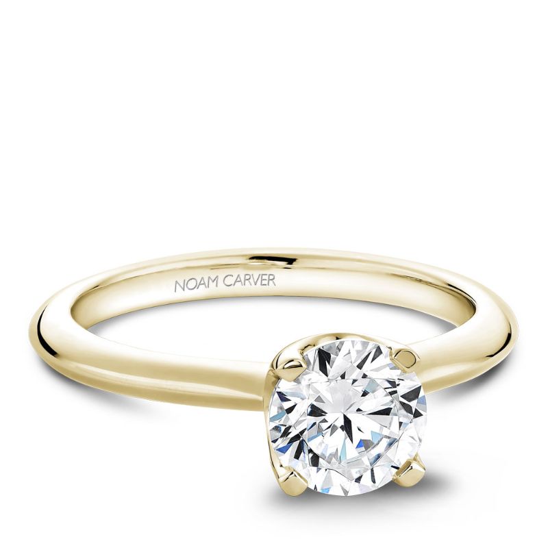 Yellow gold solitaire engagement ring with a knide edge band