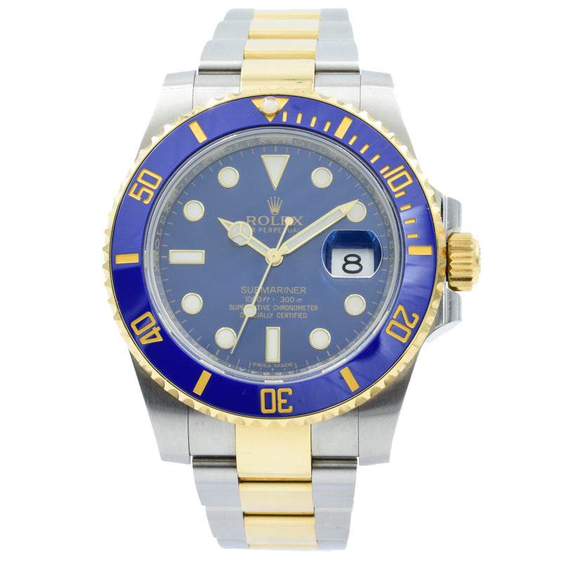 This Rolex Submariner was recently traded in to our store and comes with the original box and warranty card. This watch is in very good condition and shows only normal, minor wear. This model is in a 40mm stainless steel case featuring 18k Yellow Gold accents. The dial and ceramic bezel are blue.