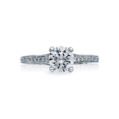 For the modern Tacori Girl; this stunning solitaire with a single string of diamonds glistening along the crisp platinum ceiling makes for a truly one of a kind engagement ring. A brilliant round center diamond is placed on the crown with grace and crafts
