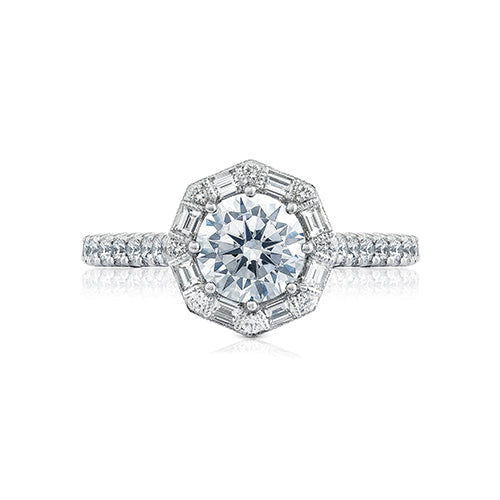 A truly regal engagement ring, this beauty features an art deco bloom with baguettes and round diamonds dancing around your round center. Brilliant pav  set diamonds in a French cut setting dance along the ceiling of the high polished band with hidden diamond details along the inner face.