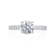 This engagement ring from the Moyer Collection was created for a bride that wants a unique touch! Fourteen emerald cuts weighing 1.22ctw diamonds cover the 3/4 of the shank. A round brilliant center diamond sits comfortably atop this gorgeous ring. Center stone not included in price. 