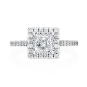 Complete with a sizable round brilliant diamond halo, this 14K White Gold engagement ring packs a big diamond look. A Princess cut center diamond sits comfortably inside the halo. Small round brilliant diamonds travel 3/4 way around the shank of this engagement ring. Center stone not included in price. 