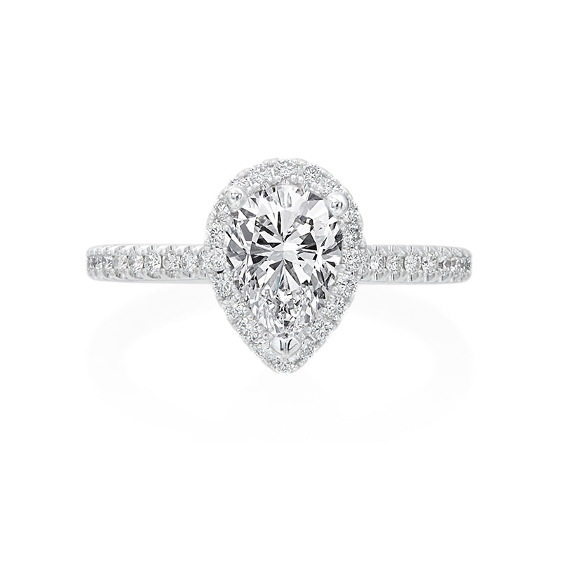 This dainty, sophisticated engagement ring in 14K White Gold puts all of the emphasis on the center pear shaped diamond. A halo of 0.35ctw round brilliant diamonds accentuates the beauty of the pear shape. Under the cathedral style head is a small single diamond- a nice touch for the wearer! Center stone not included in pricing. 