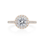 Our take on the classic halo engagement ring with diamonds down the sides of the ring. We love the high cathedral style setting of this engagement ring. This ring, like all other engagement rings in the Moyer Collection is complete with a small sapphire set in the inside of the shank. Center stone is not included in the pricing. 