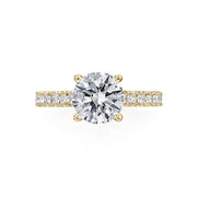 This Moyer Collection semi-mount focuses all eyes on the center stone. Diamonds travel 3/4 way around the 14K Yellow Gold band, and a small halo of diamonds stretches around the base of the prongs. Center stone not included in the pricing. 