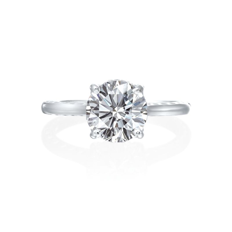 Jack Kelege makes the most beautiful solitaire engagement rings that have gorgeous hidden details for the wearer to enjoy. From the side profile, the wearer gets a glimpse of the hidden diamond bezel halo underneath the head of the mounting. On the shank of the mounting are beautiful etched carvings and intricate milgrain detail.  Center diamond is not included in the price shown. 