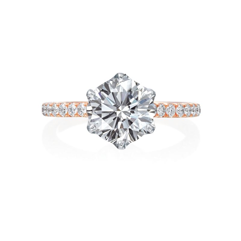 This Jack Kelege engagement ring is a work of art. From the top, the center diamond featured in a 6-prong white gold head which gives the diamond a more bright white look. The shank of the mounting is a beautiful rose gold band with a row of sparkling white diamonds. From the side profile, the wearer enjoys additional intricate diamond detail and gorgeous milgrain work. Center diamond is not included in the price shown. 