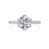 This Jack Kelege engagement ring is a work of art. From the top, the center diamond featured in a 6-prong white gold head which gives the diamond a more bright white look. The shank of the mounting is a beautiful rose gold band with a row of sparkling white diamonds. From the side profile, the wearer enjoys additional intricate diamond detail and gorgeous milgrain work. Center diamond is not included in the price shown. 