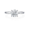 From the top view of this engagement ring, this ring is a simple 18k white gold solitaire. However from the side profile, the wearer can enjoy a row of bezel set diamonds traveling half way around on both sides of the ring. This ring is perfect for the bride who wants a solitaire but delights in the beauty of hidden diamond details. Center diamond is not included in the price shown. 