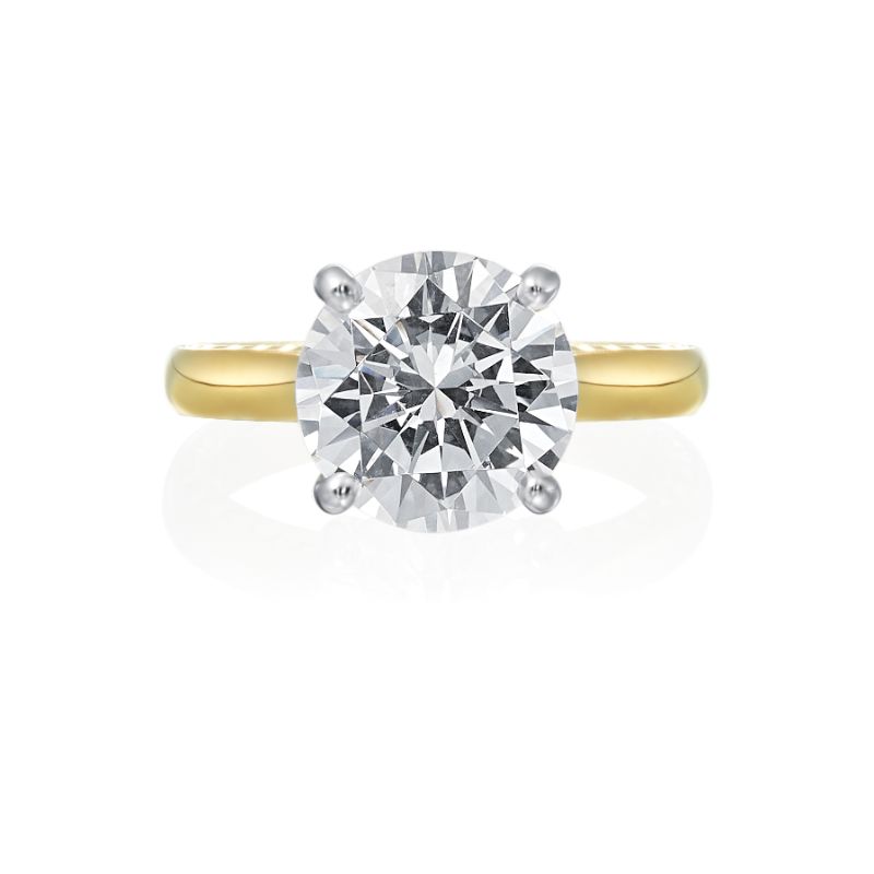 Jack Kelege makes the most beautiful solitaire engagement rings that have gorgeous hidden details for the wearer to enjoy. Although the shank of the ring is made in 18K yellow gold, the diamond is set in a 18K white gold head to reflect bright white light.  From the side profile, the wearer gets a glimpse of beautiful etched carvings and intricate milgrain detail. Center diamond is not included in the price shown. 