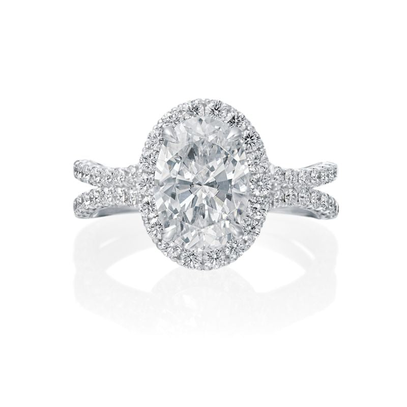 The center oval diamond is surrounded by a beautiful diamond halo and split shank. On the profile, milgrain and etching details are visible to the bride. Center diamond is not included in the price shown. 