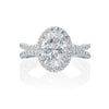 The center oval diamond is surrounded by a beautiful diamond halo and split shank. On the profile, milgrain and etching details are visible to the bride. Center diamond is not included in the price shown. 