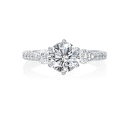 This Jack Kelege engagement ring has beautiful details from every angle. The center round brilliant diamond is framed by two smaller round brilliant diamonds weighing 0.28ctw for a classic three-stone look. On the profile of the ring are intricate diamond, milgrain and etched details that will delight any bride to be! Center diamond is not included in the price shown. 