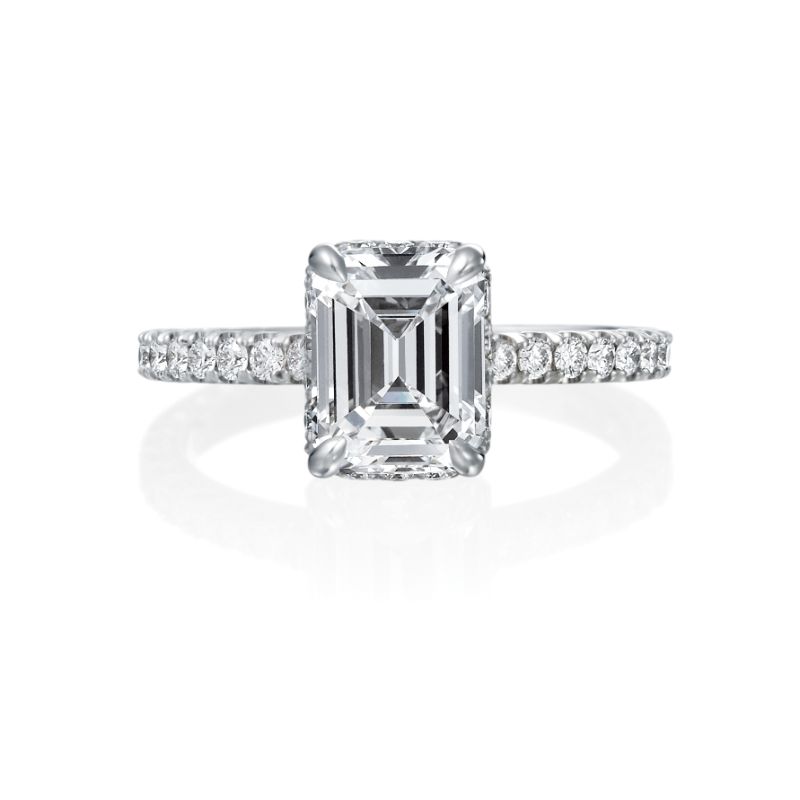 Jack Kelege makes the most beautiful engagement rings that have gorgeous hidden details for the wearer to enjoy. From the top, the wearer sees a beautiful emerald cut diamond with small round brilliant diamonds traveling half way around the shank. From the side profile, the wearer gets a glimpse of the beautiful etched carvings and intricate milgrain detail.  Center diamond is not included in the price shown. 
