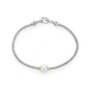 A freshwater cultured pearl station with Caviar beading in 18K gold and sterling silver on this versatile bracelet. Finished with a signature lobster clasp detailing the LAGOS crest in 18K gold.- Sterling Silver & 18K Gold- Signature Lobster Clasp- Width 3mm- Pearl measures 9mm- STYLE #: 05-81171