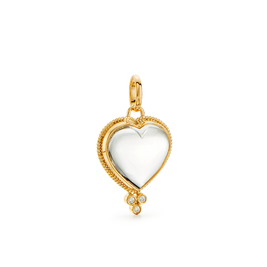 The 18K Rock Crystal Heart is our interpretation of the ancient symbol of emotion, affection and love. Delicate golden braids embrace a finely polished, natural rock crystal. This timeless jewel is available in multiple sizes and layers beautifully with our amulets and other pendants.  We love our crystal hearts on our gold chains or on a leather cord.  The large rock crystal heart pendant on our 18K Leather Cord in red is particularly striking.18K GoldNatural Rock Crystal0.10cts of DiamondsSize