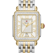 This two-tone Deco Madison offers a sleek take on the classic Deco with gold-plated Roman numeral indexes on the silver sunray dial and 155 diamonds covering the bezel and dial. The two-tone bracelet is interchangeable with any 18mm MICHELE strap.