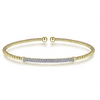 This bangle bracelet is one of the more unique items in our collection. The space between each end is smaller to appear as if its one continuous loop. The beaded band comes together supporting the dazzling diamonds in the center. Impossibly tiny diamonds come together to create a look that celebrates the part and the whole. The closely-packed together diamonds look like a diamond thats been stretched out but, on closer look, you can see each individual diamond in all of its glory.  