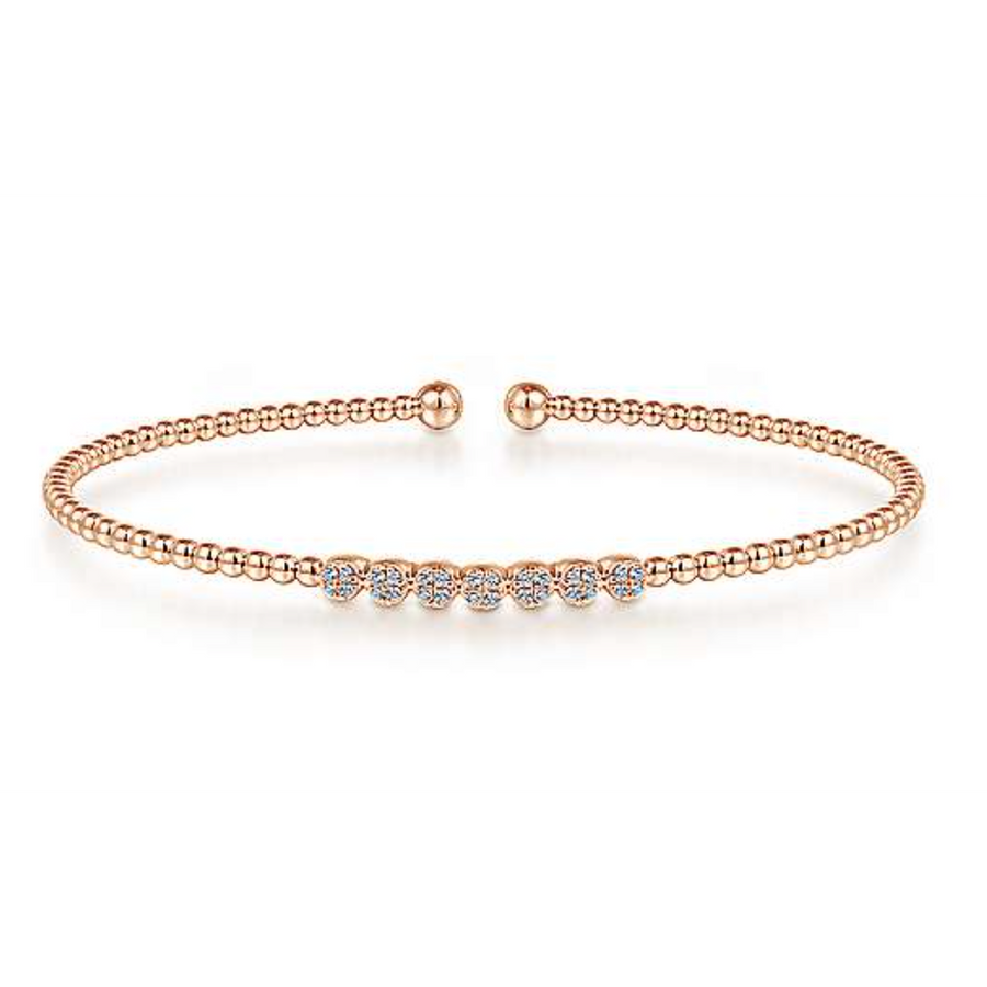 For a stylish look thats simple and subtle, this beautiful bangle is a perfect compliment to your outfit. The bracelet is connected through beads in 14K rose gold. This fashionable piece of jewelry is finished off with seven circles of pristine pav diamonds for a sparkle that will make an impression without being overwhelming.  