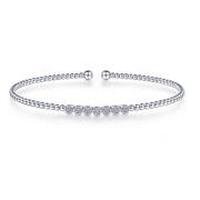 For a stylish look thats simple and subtle, this beautiful bangle is a perfect compliment to your outfit. The bracelet is connected through beads in 14K white gold. This fashionable piece of jewelry is finished off with seven circles of pristine pav diamonds for a sparkle that will make an impression without being overwhelming.  