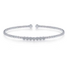 For a stylish look thats simple and subtle, this beautiful bangle is a perfect compliment to your outfit. The bracelet is connected through beads in 14K white gold. This fashionable piece of jewelry is finished off with seven circles of pristine pav diamonds for a sparkle that will make an impression without being overwhelming.  