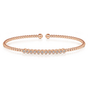Crisp pave diamonds take center stage in this pink gold bangle.