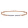 A bangle that is equal parts sparkling and stunning. The bracelets 14K rose gold beads instantly grab attention due to their unique pink color. The beads seamlessly transition into two dramatic displays of sparkle and style with .30 carats of diamonds. It doesnt matter where you wear this bracelet - youll always look great.