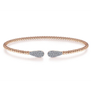 Diamond ends connected with a string of rose gold make this bangle something everyone will love looking at. 14K rose gold beads give this bracelet a glow thats in style now and will be in style in the future. Each end of the bracelet has a group of prismatic pav diamonds in the shape of a teardrop for a sparkle that will surely start conversation. 