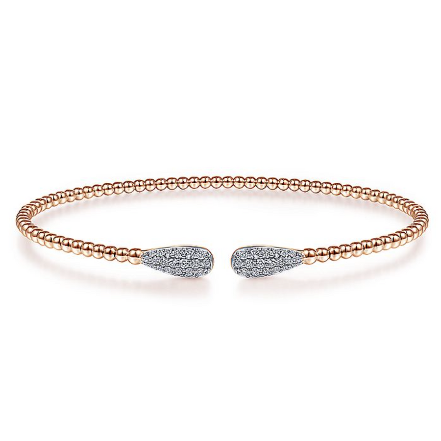 Diamond ends connected with a string of rose gold make this bangle something everyone will love looking at. 14K rose gold beads give this bracelet a glow thats in style now and will be in style in the future. Each end of the bracelet has a group of prismatic pav diamonds in the shape of a teardrop for a sparkle that will surely start conversation. 