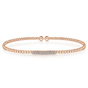 The words stylish and sweet will come to the mind of anyone who sees you wearing this bangle. Delicate touches of 14K rose gold combine with a simple bar of pristine diamonds. You can pair this bracelet with other jewelry for a fashionable mix, or wear by itself for an understated compliment to your wardrobe.   