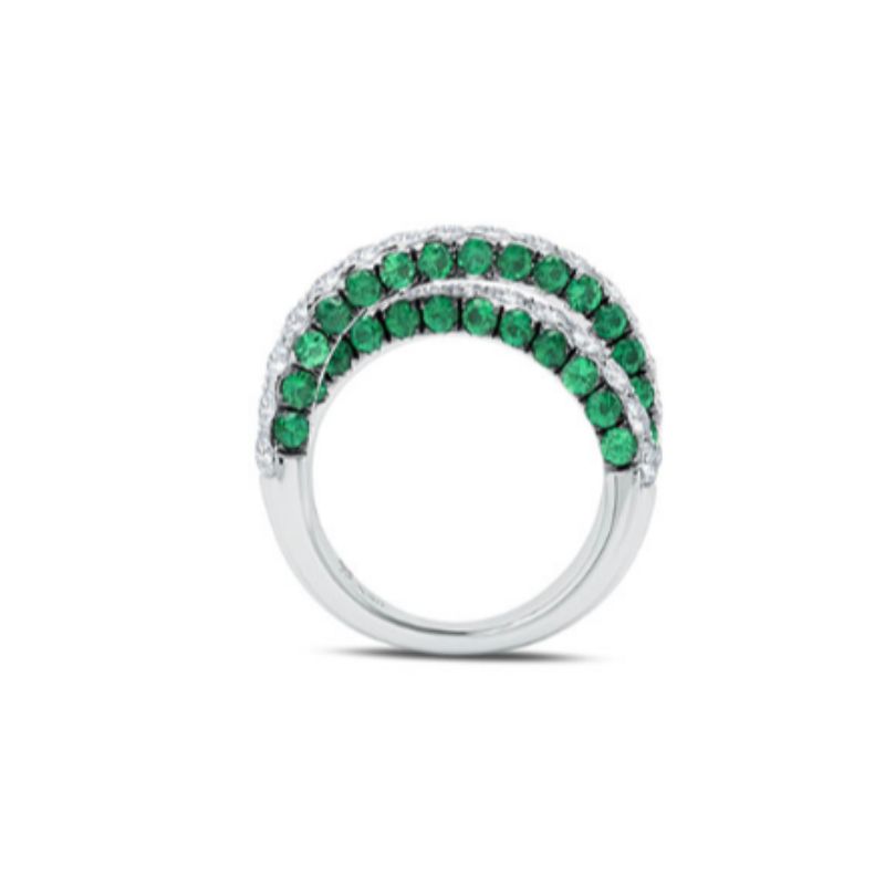 This 18K white gold x ring has 2.98 carat total weight emeralds and 1.83 carat total weight G-H color white diamonds. White diamonds sparkle from the front of the ring, and on the side profiles of the ring, emeralds accent the diamonds. 